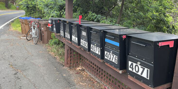 Mailboxes After: The postman/woman has been; there’s mail in the box with the red flag raised.